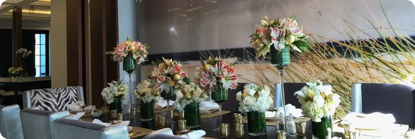 A table with many vases of flowers on it