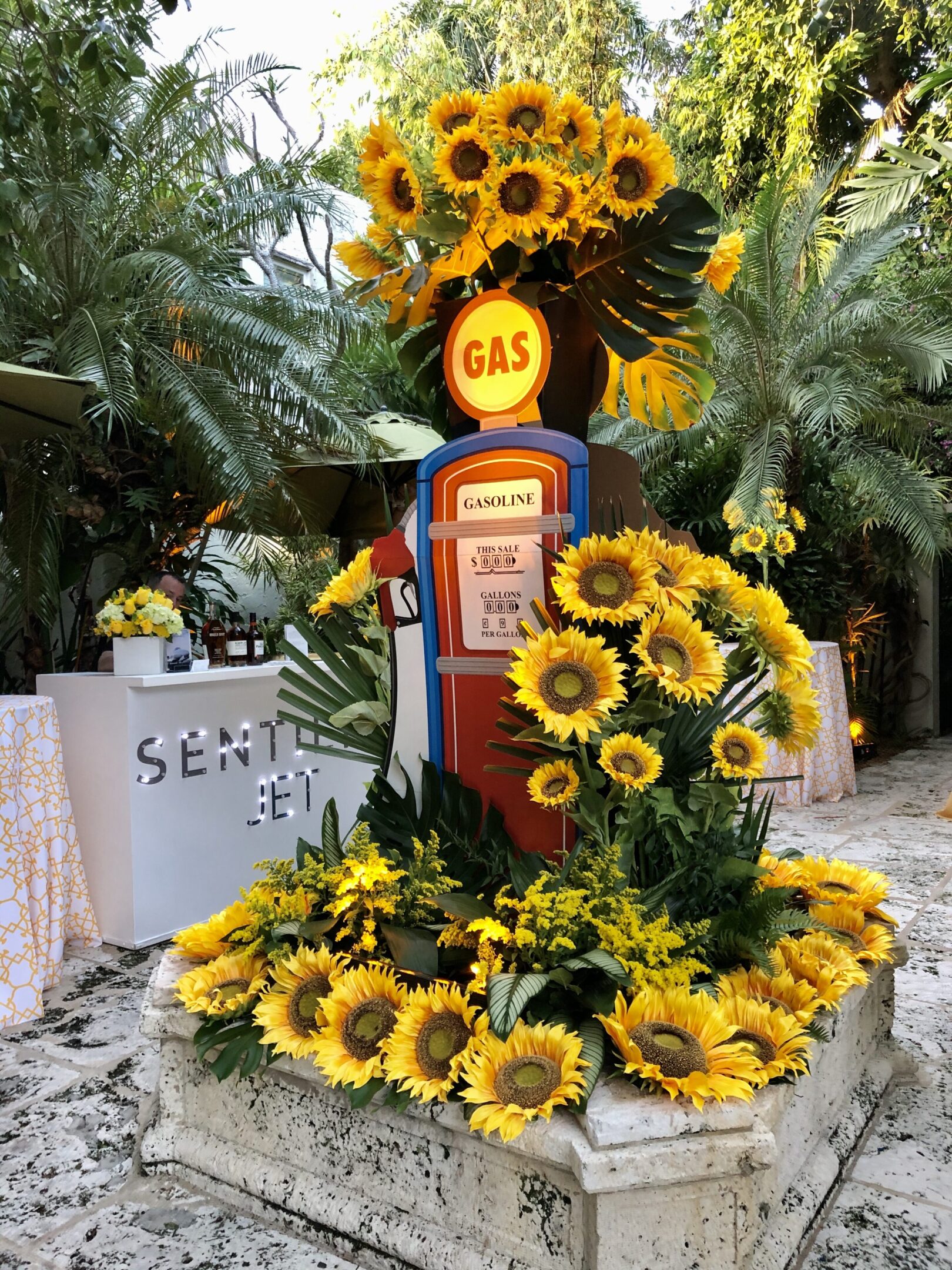 A gas pump with sunflowers in it